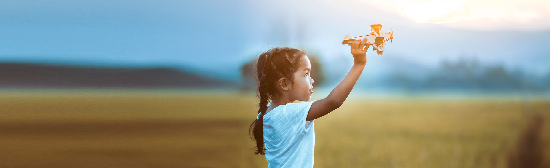 child flying toy plane