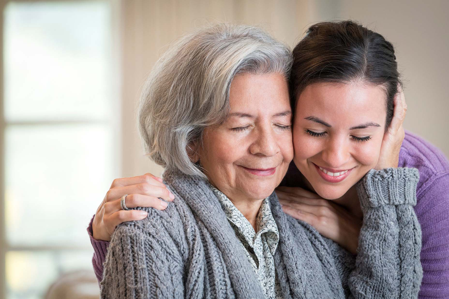 elderly and young woman embracing