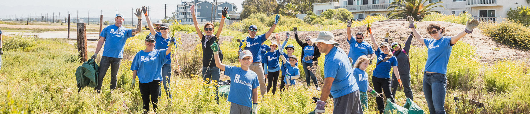 group of people in field wearing socalgas shirts