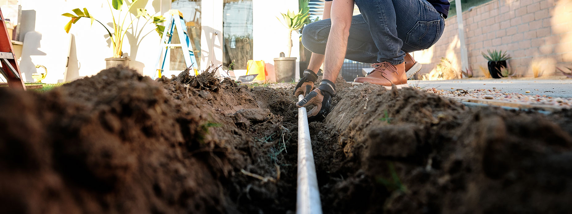 Man holding gas pipeline dirt