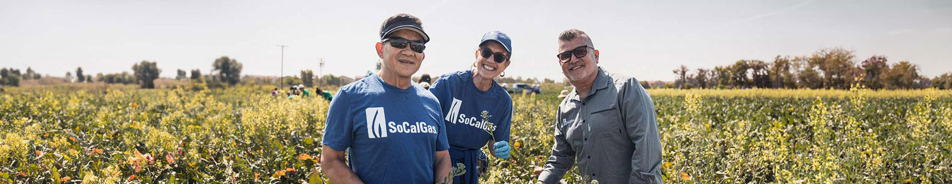 socalgas employees smiling in grass field