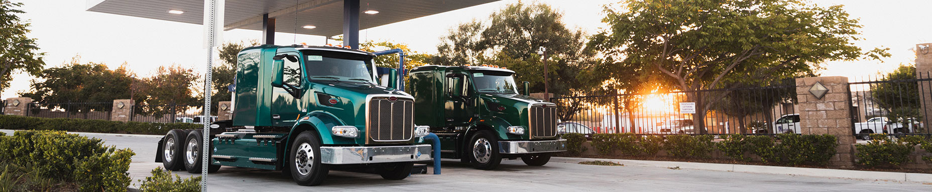 big rig trucks refueling at gas station