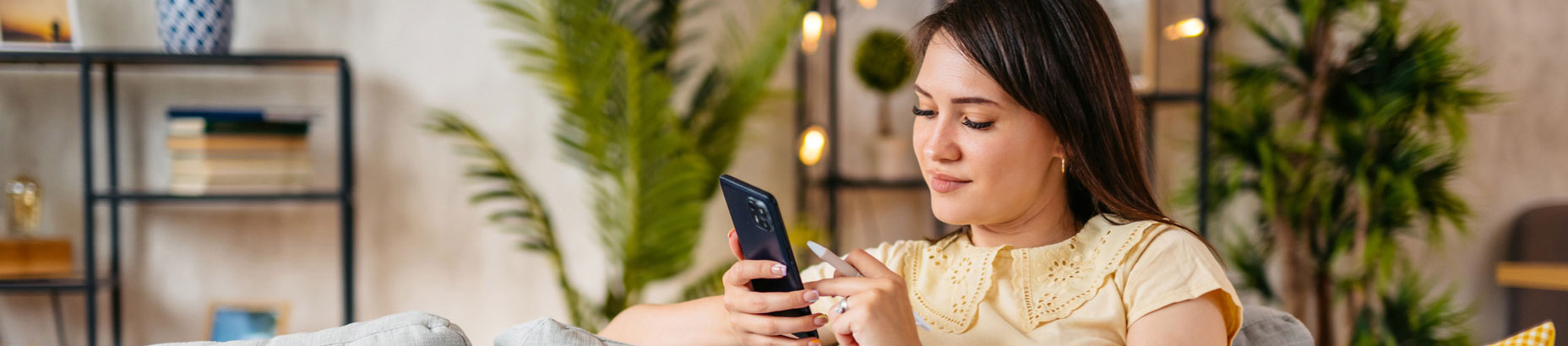 woman sitting on couch with phone