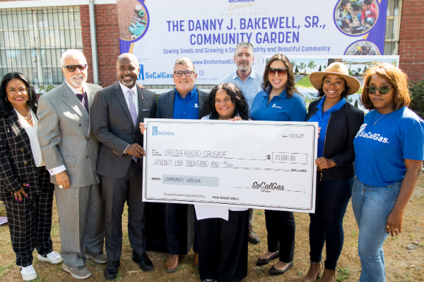 Representatives from Brotherhood Crusade and SoCalGas presenting a check