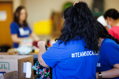 Employees volunteer to sort clothing items