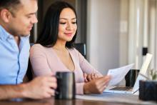 couple with coffee reading bill