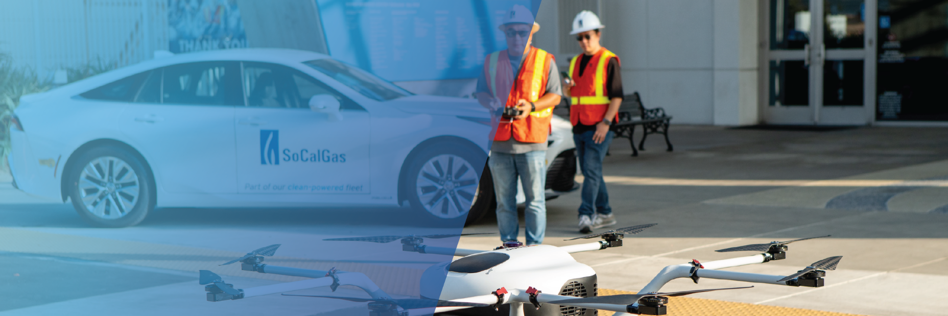 men in reflective gear powering up drone with socalgas toyota car in the background