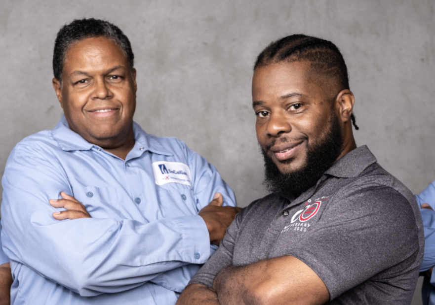 4 workers standing with their arms crossed