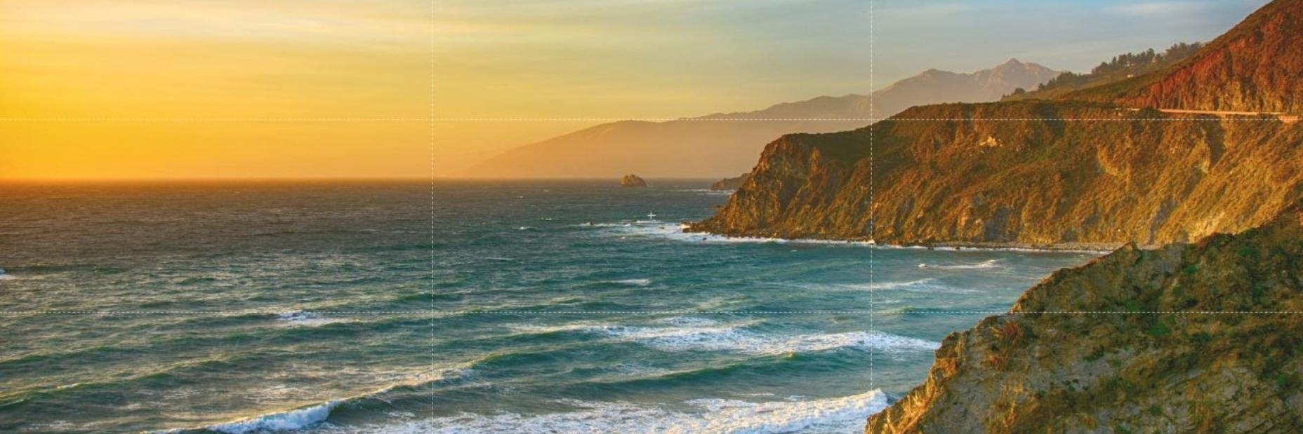 image of the coast with the ocean on the left and mountains on the right