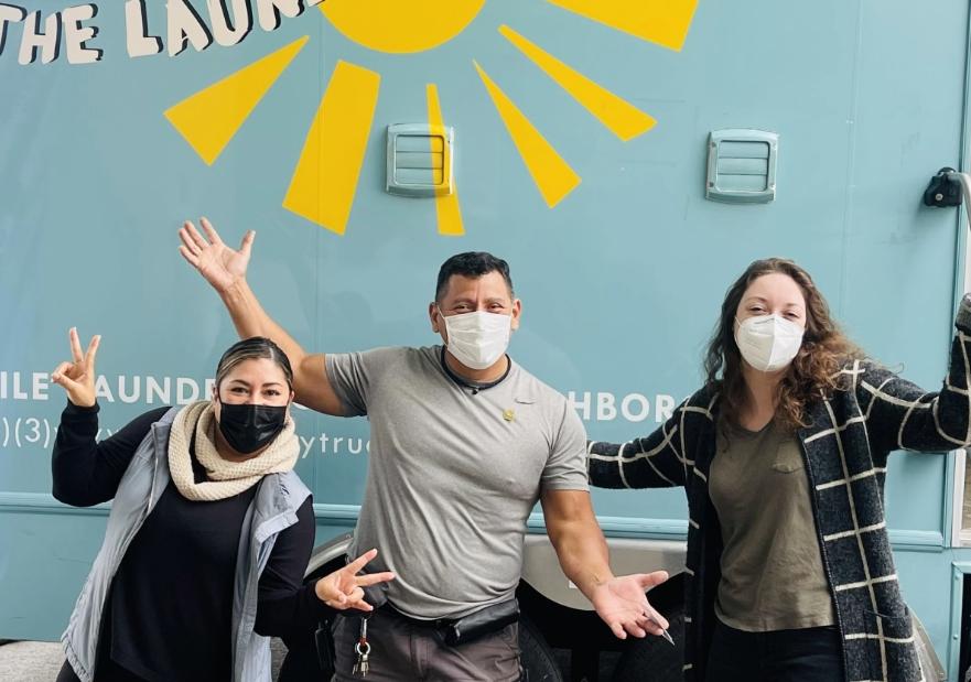 laundry truck la posing in front of their truck